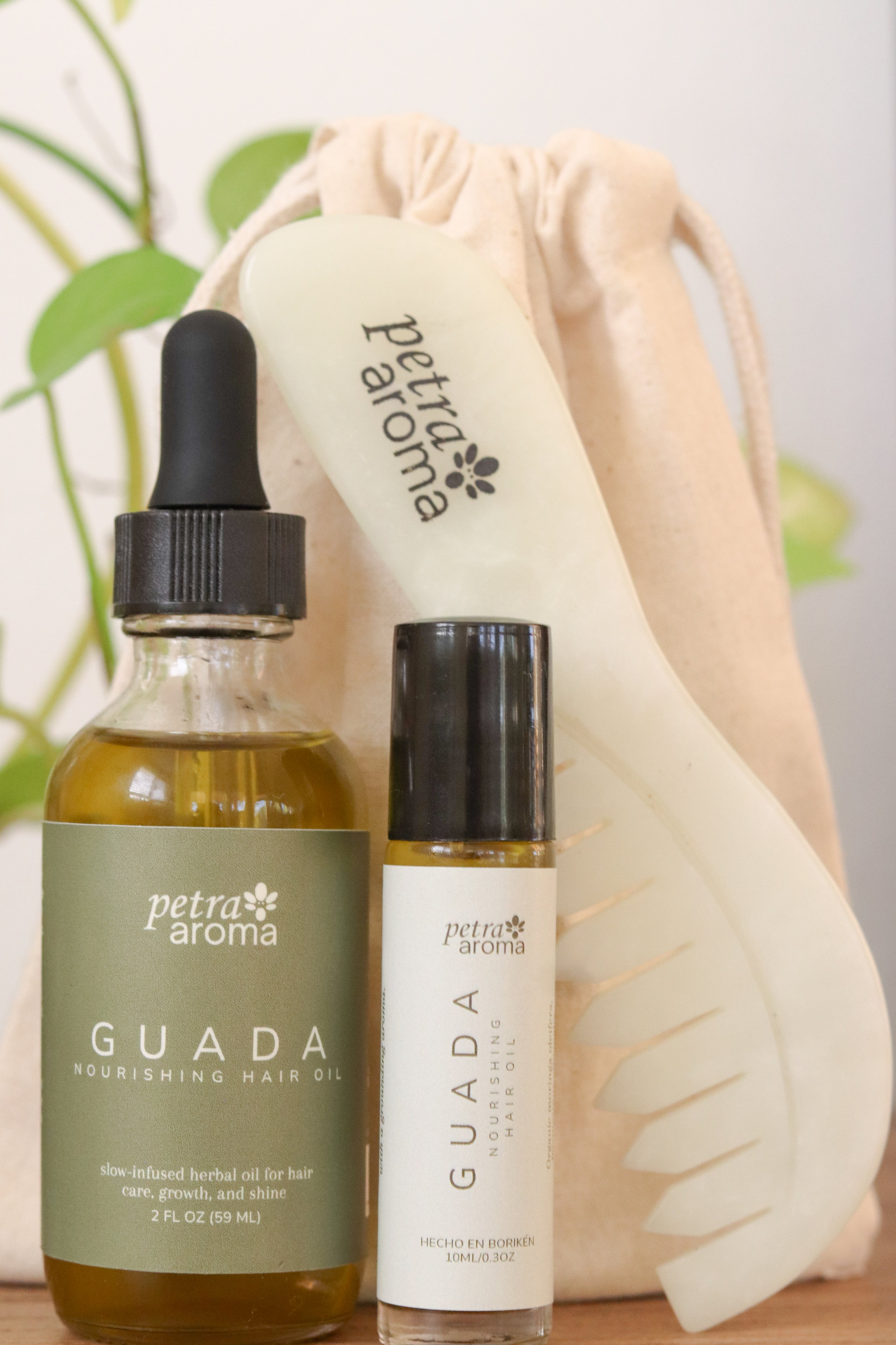 Petra Aroma Guada nourishing hair oil and serum with a branded pouch on a light background.