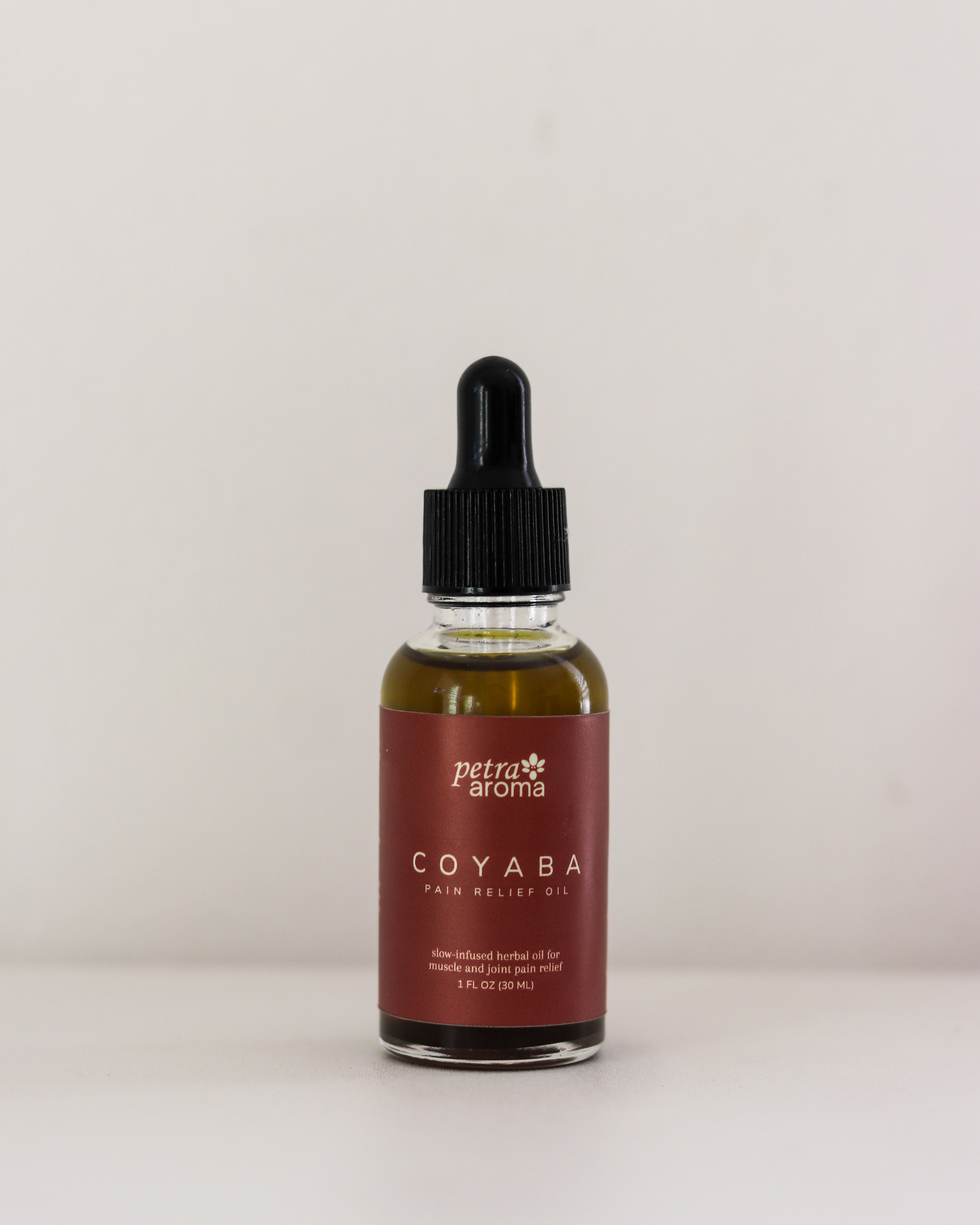 Bottle of petra aroma COYABA hair growth oil on a white background