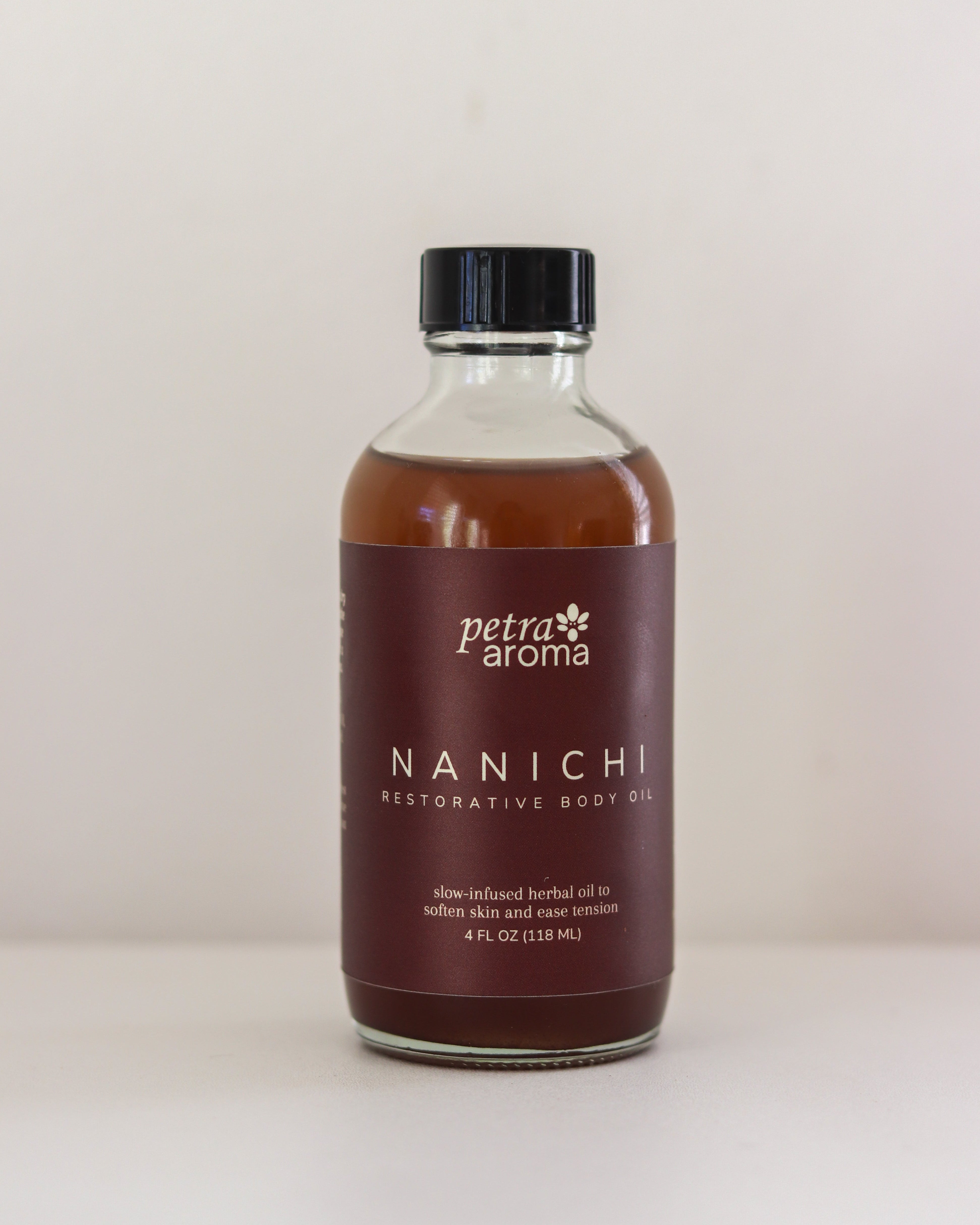 Bottle of Petra Aroma Nanichi Restorative Body Oil on a white background