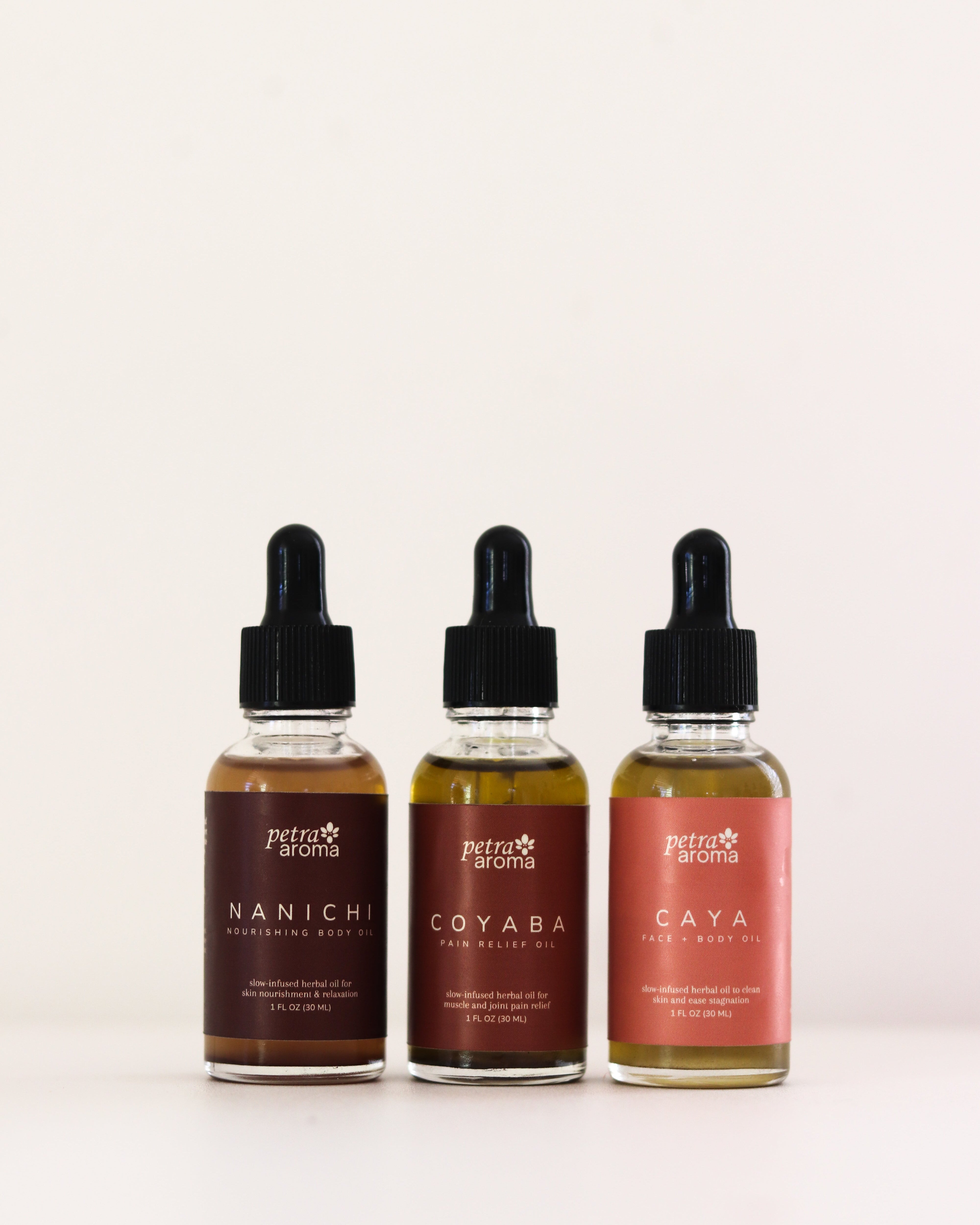 Three bottles of petro aromas with droppers on a white background