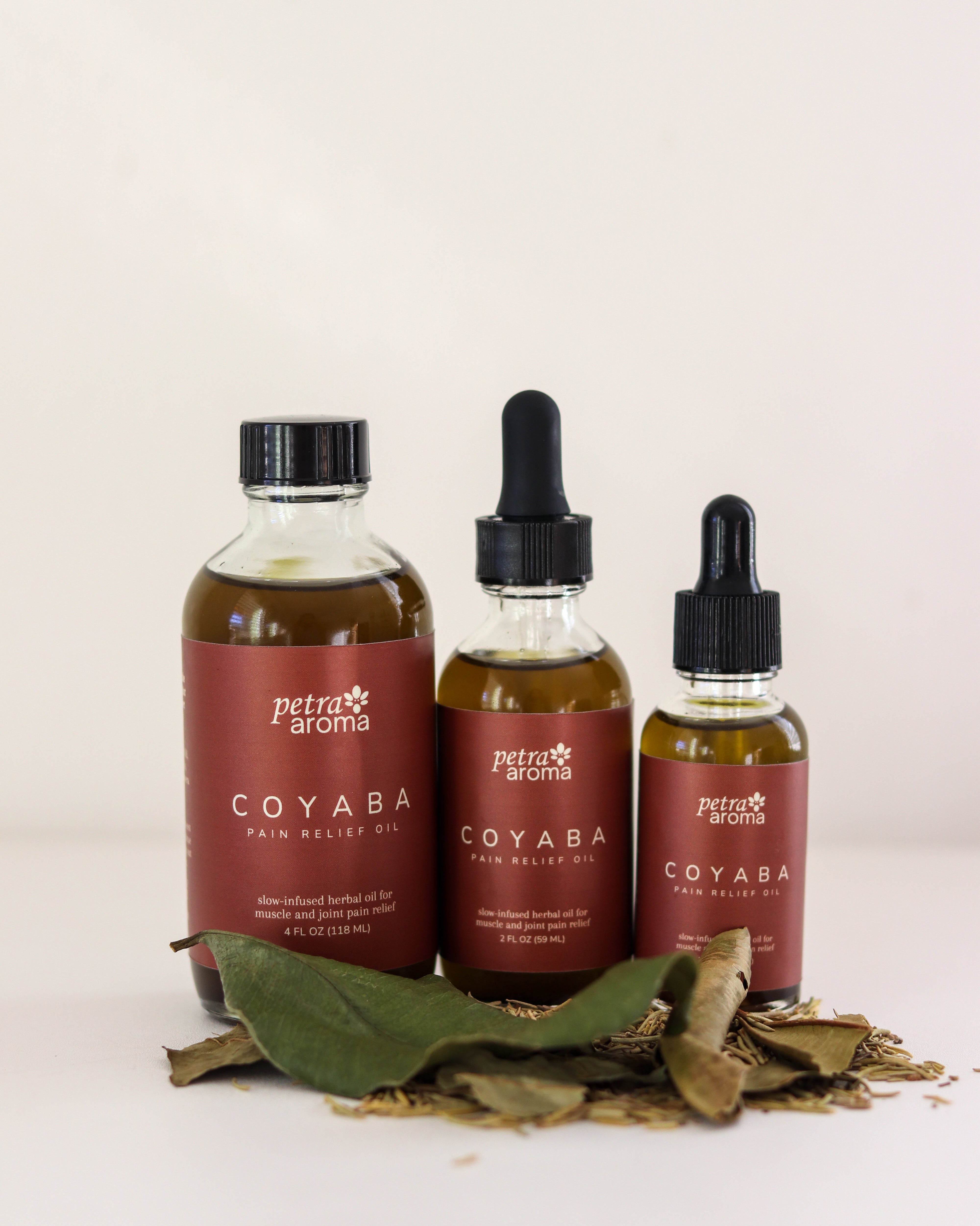 Three bottles of petrá aroma Coyaba oil on a light background